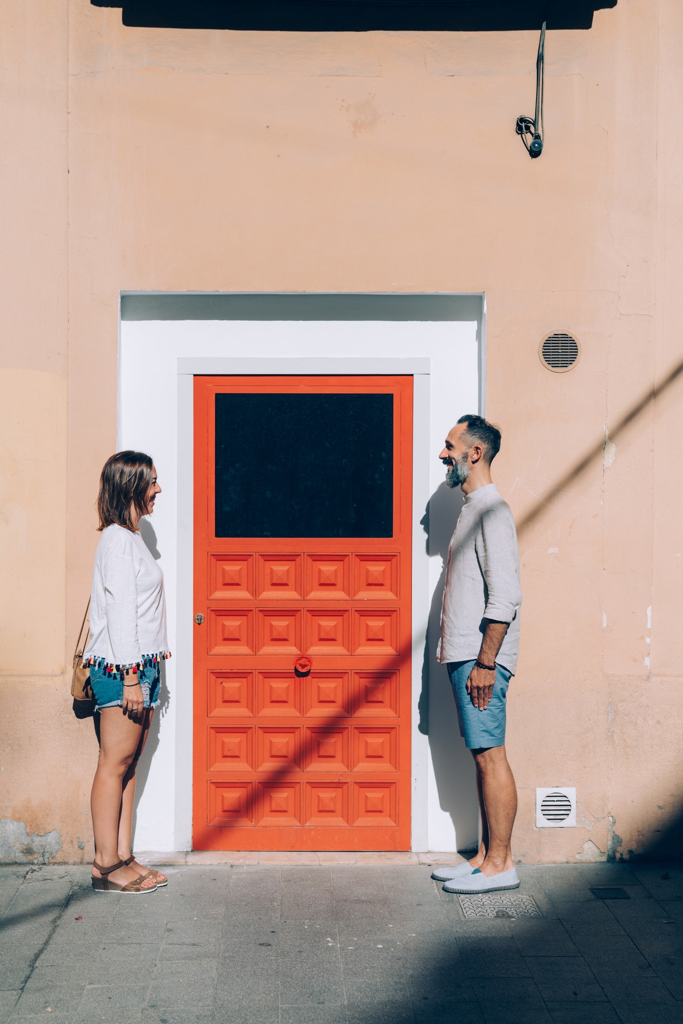 adult couple posing outdoors looking in the eye