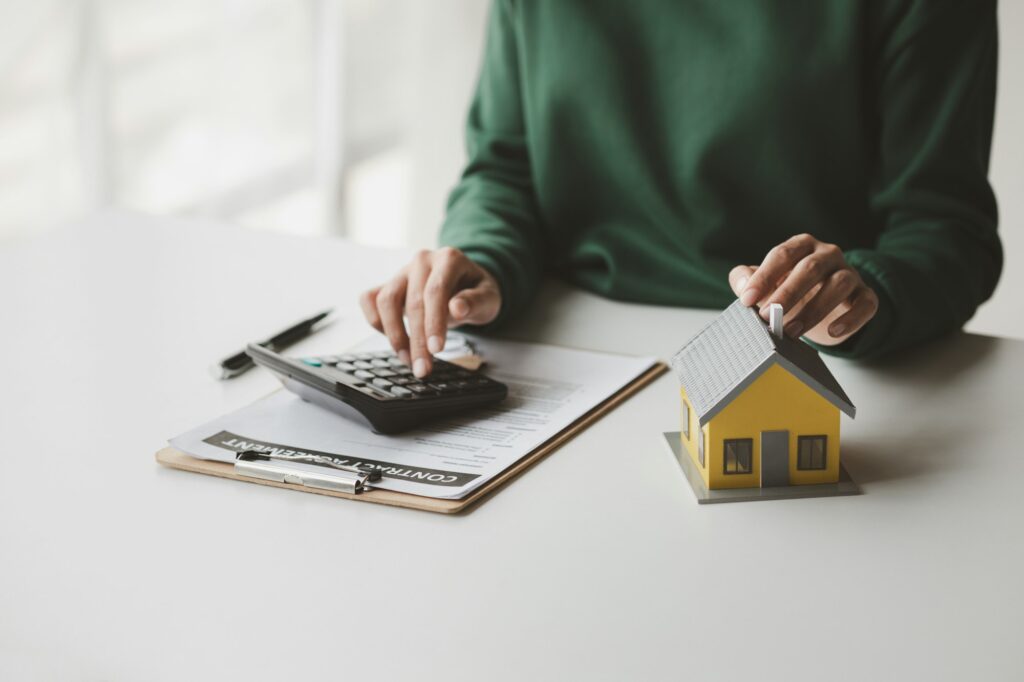 The salesperson of the housing estate in the project is preparing and verifying the contract of sale